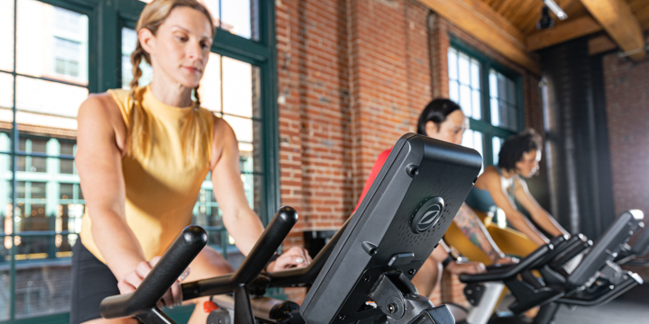 Group of people using Surge Cycle Bikes in a fitness center