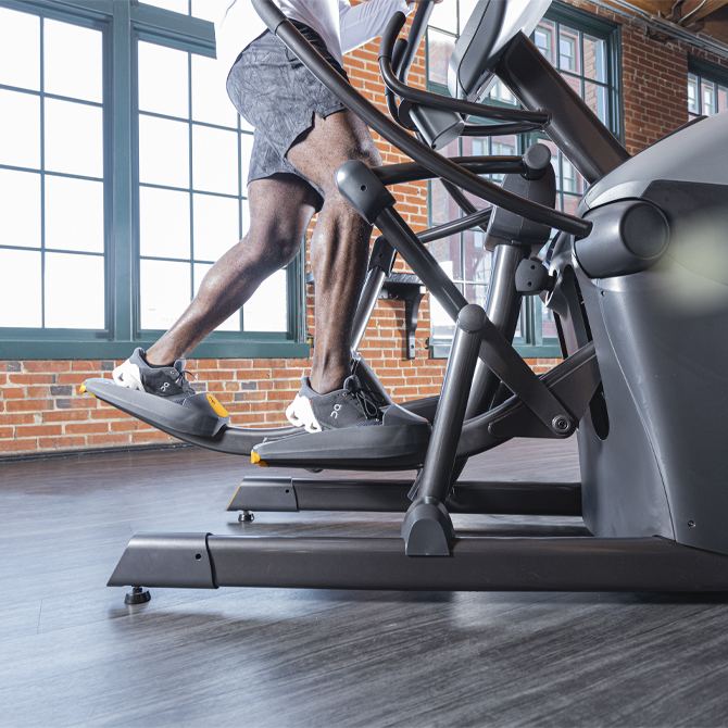 Man working out on the XT-One standing elliptical - lower body focus