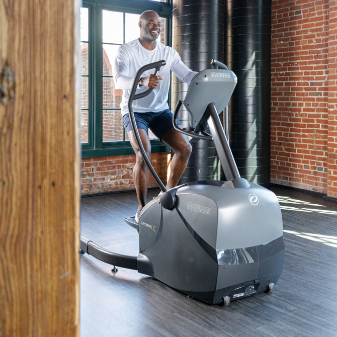 Man using lateral elliptical - front view